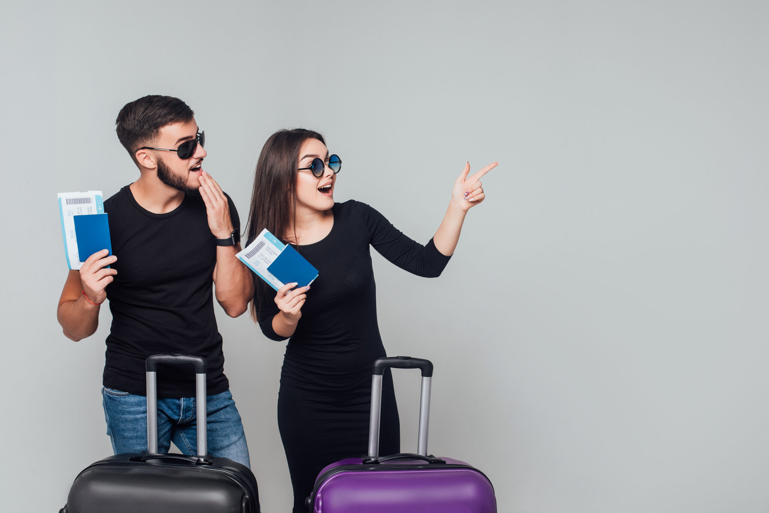 Home smiling young happy couple with suitcases ticket around isolated white